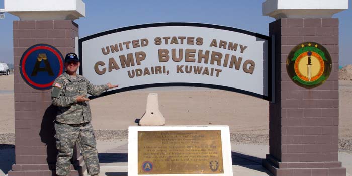 Me wearing a Starship Modeler cap at the entrance to Camp Buehring.